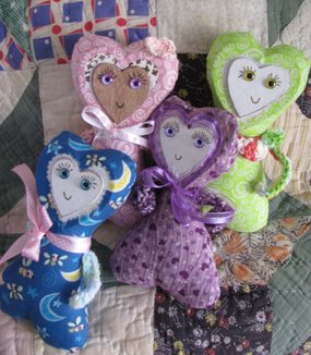 Jerrys Quilt Used as Background For Photo Shoot of Folk Heart Dolls